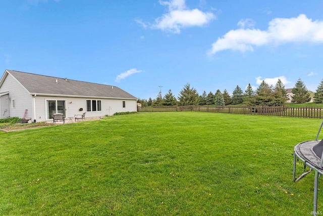 view of yard featuring a patio, a fenced backyard, and a trampoline
