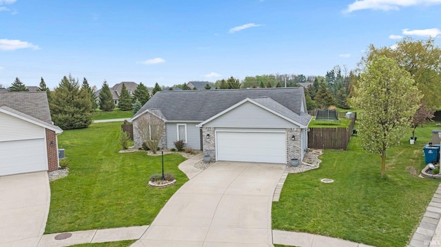 view of front of house with a garage, a shingled roof, concrete driveway, and a front lawn