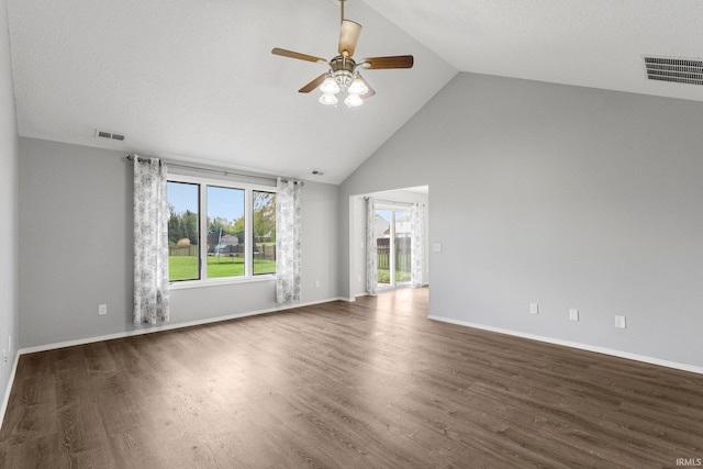 spare room with visible vents, wood finished floors, baseboards, high vaulted ceiling, and a ceiling fan