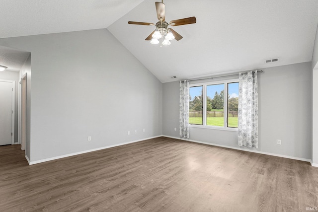 spare room featuring ceiling fan, visible vents, wood finished floors, and lofted ceiling