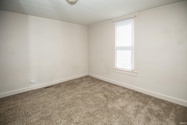 empty room featuring baseboards and carpet