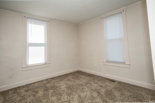 empty room with carpet floors and baseboards