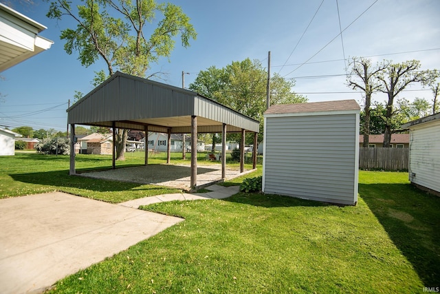 view of yard with a patio, an outbuilding, and a shed