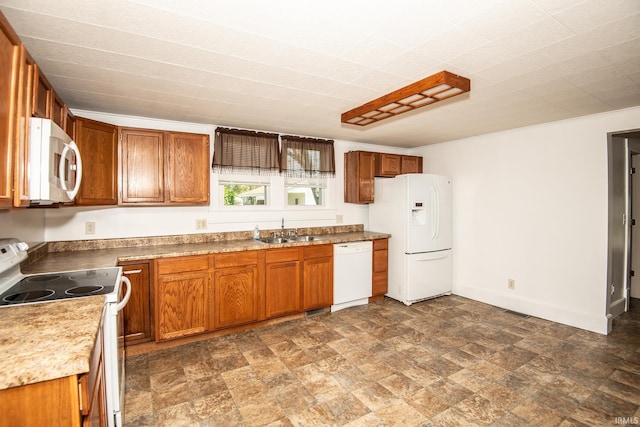 kitchen featuring a sink, brown cabinets, white appliances, and visible vents