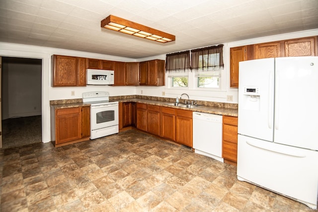 kitchen featuring white appliances, dark countertops, and brown cabinetry