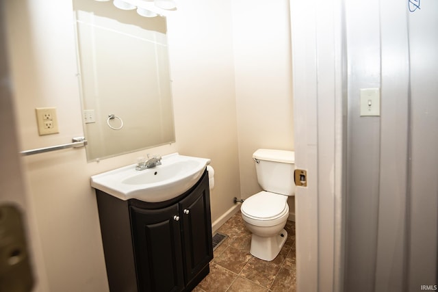 bathroom featuring vanity, baseboards, and toilet
