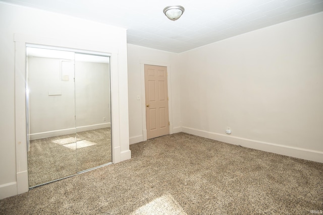 unfurnished bedroom featuring a closet, carpet, and baseboards