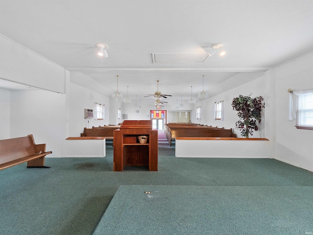 interior space with ceiling fan, attic access, and carpet flooring