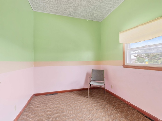 unfurnished room featuring carpet flooring, baseboards, and visible vents