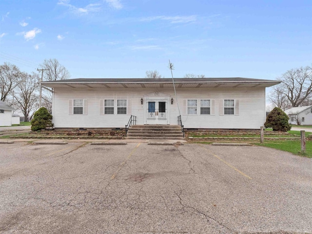 view of front of home with uncovered parking, french doors, and crawl space