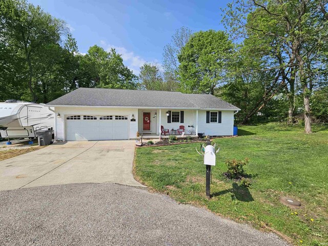 ranch-style home featuring a front lawn, covered porch, roof with shingles, concrete driveway, and an attached garage