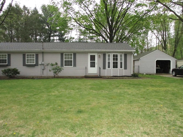 ranch-style home featuring entry steps, an outdoor structure, a front yard, and a garage