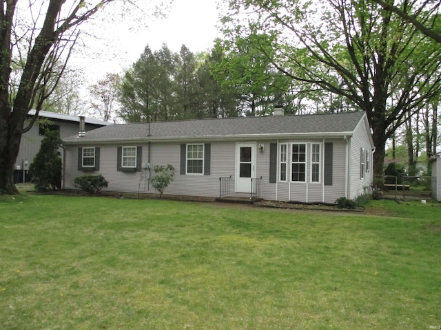 ranch-style home with a front lawn and a chimney