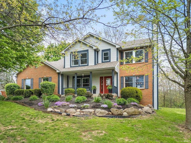 traditional-style house featuring a porch, brick siding, a shingled roof, and a front lawn