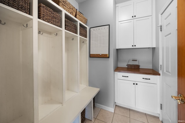 mudroom featuring light tile patterned flooring and baseboards