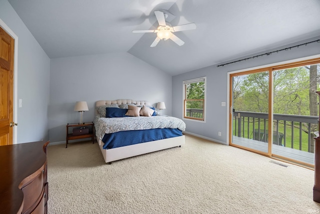 carpeted bedroom with access to outside, baseboards, multiple windows, and lofted ceiling