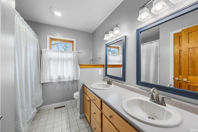 bathroom with visible vents, plenty of natural light, and a sink