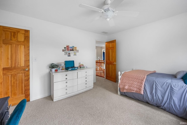 bedroom with a ceiling fan, light colored carpet, and visible vents