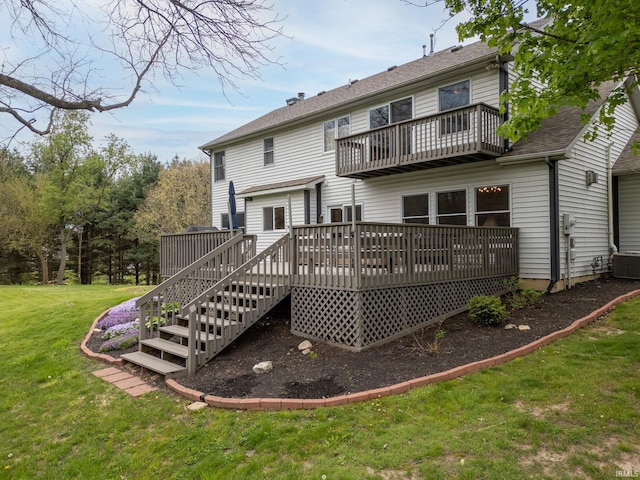 back of house featuring a lawn, a shingled roof, a wooden deck, and a balcony