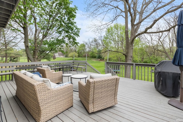 wooden terrace with a lawn, outdoor dining area, and area for grilling