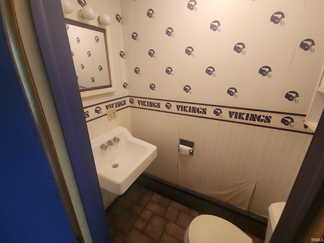 2708 Elmwood Dr, Logansport, IN 46947 - half bathroom with a sink, a wainscoted wall, and toilet