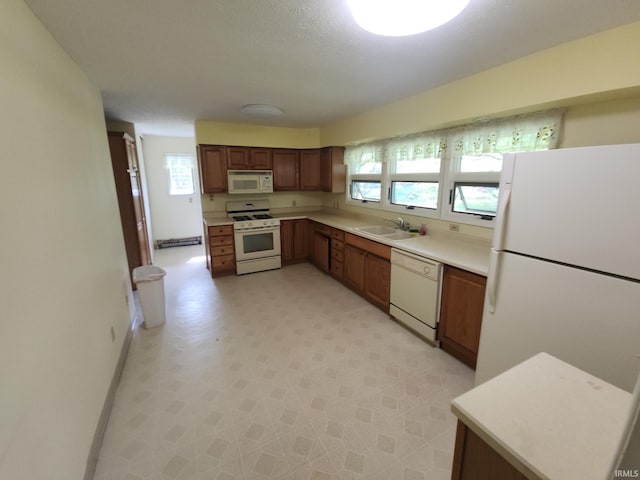 2708 Elmwood Dr, Logansport, IN 46947 - kitchen featuring light countertops, baseboards, a sink, light floors, and white appliances