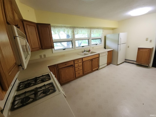 2708 Elmwood Dr, Logansport, IN 46947 - kitchen featuring brown cabinets, a sink, light countertops, light floors, and white appliances