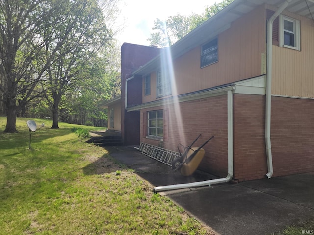 2708 Elmwood Dr, Logansport, IN 46947 - view of property exterior with brick siding and a yard