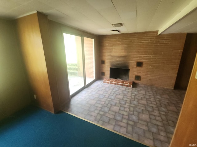 2708 Elmwood Dr, Logansport, IN 46947 - unfurnished living room featuring visible vents, a large fireplace, and brick floor