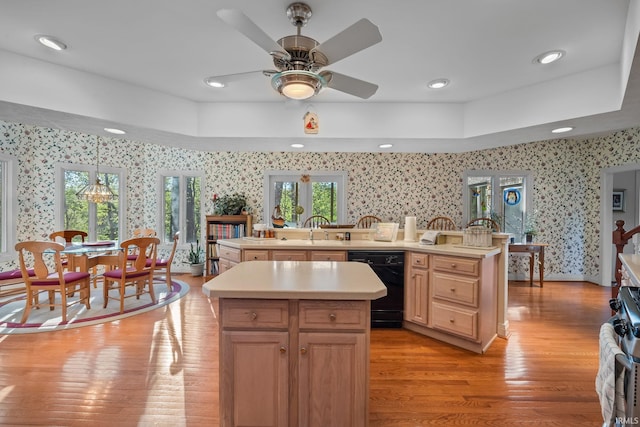 kitchen featuring light countertops, a center island with sink, wallpapered walls, and dishwasher