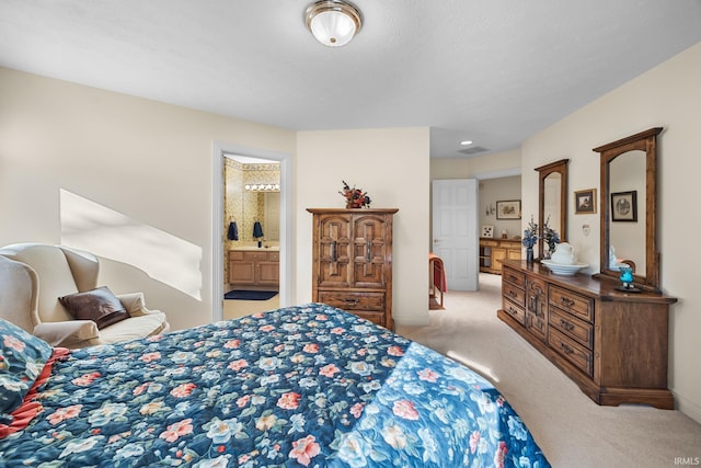bedroom featuring carpet floors, baseboards, visible vents, and connected bathroom
