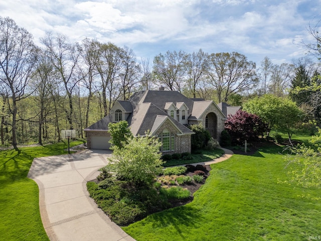 view of side of home featuring a garage, a yard, and concrete driveway