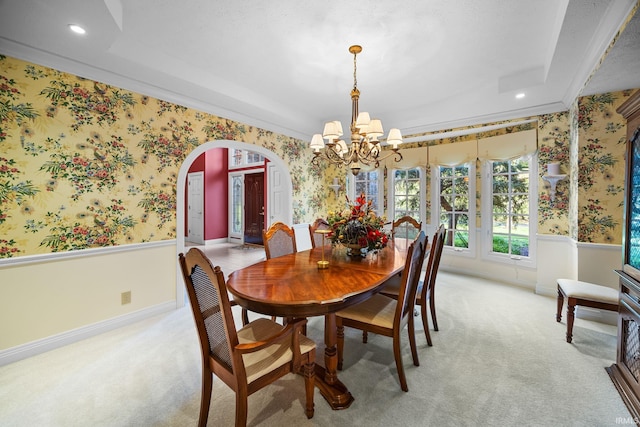 dining area featuring arched walkways, wainscoting, wallpapered walls, and a chandelier