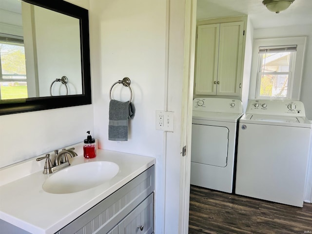 bathroom featuring vanity, washing machine and dryer, and wood finished floors