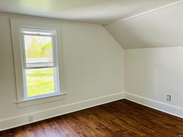 bonus room with dark wood-style flooring, baseboards, and vaulted ceiling