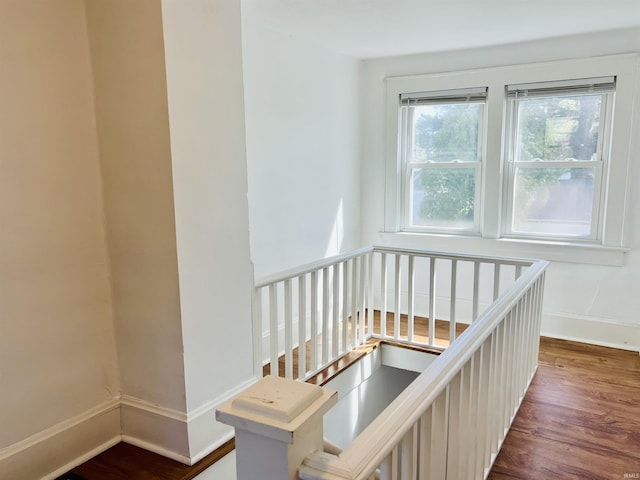 stairs with baseboards and wood finished floors
