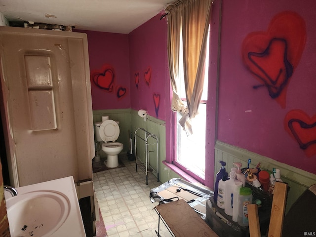 1217 Smead St, Logansport, IN 46947 - bathroom with a sink, wainscoting, tile patterned floors, and toilet