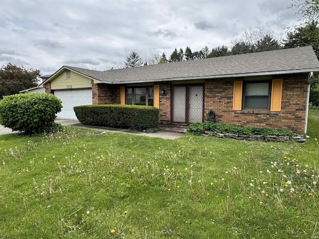 ranch-style house with brick siding, a front lawn, and a garage