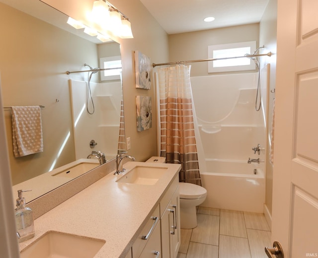 bathroom featuring toilet, a healthy amount of sunlight, and a sink