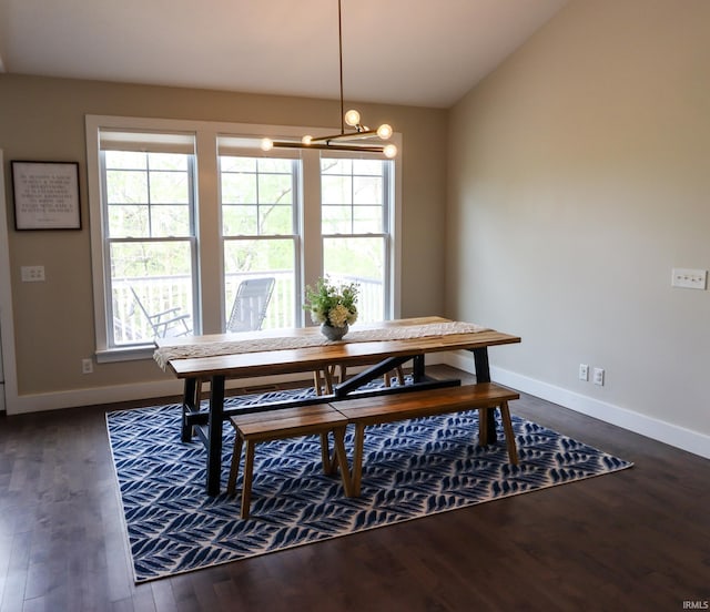 dining space with dark wood-type flooring, a chandelier, and a wealth of natural light