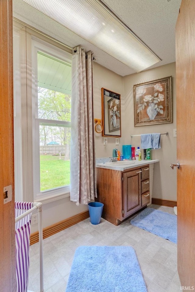 479 W 250 S, Wabash, IN 46992 - bathroom featuring plenty of natural light, baseboards, vanity, and tile patterned floors