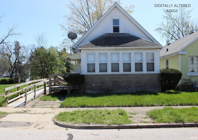 1614 Longley Ave, South Bend, IN 46628 - view of side of property with stone siding, a shingled roof, and fence