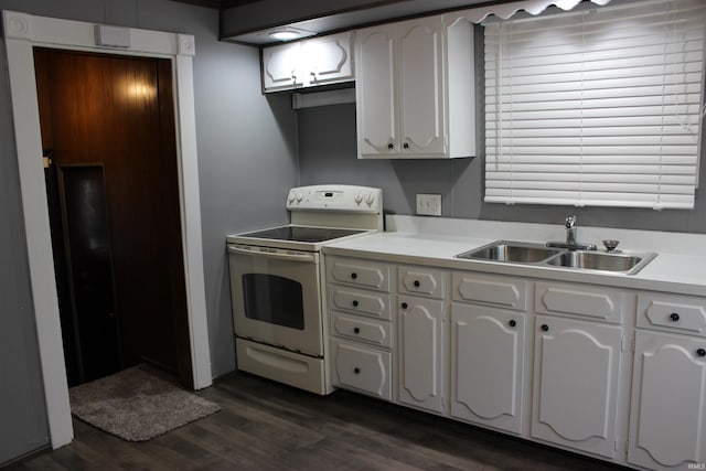 1614 Longley Ave, South Bend, IN 46628 - kitchen with white electric stove, a sink, dark wood-type flooring, light countertops, and white cabinets