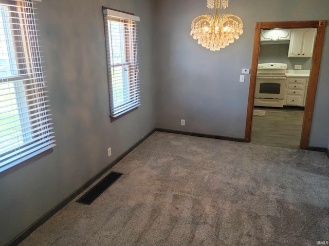 1614 Longley Ave, South Bend, IN 46628 - spare room with carpet flooring, a notable chandelier, visible vents, and baseboards