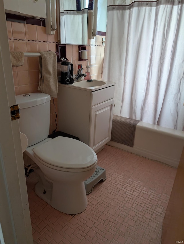 full bath with vanity, shower / bathtub combination with curtain, brick patterned floor, and toilet