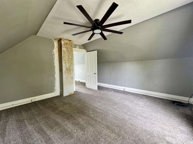 additional living space featuring carpet flooring, a ceiling fan, baseboards, and vaulted ceiling