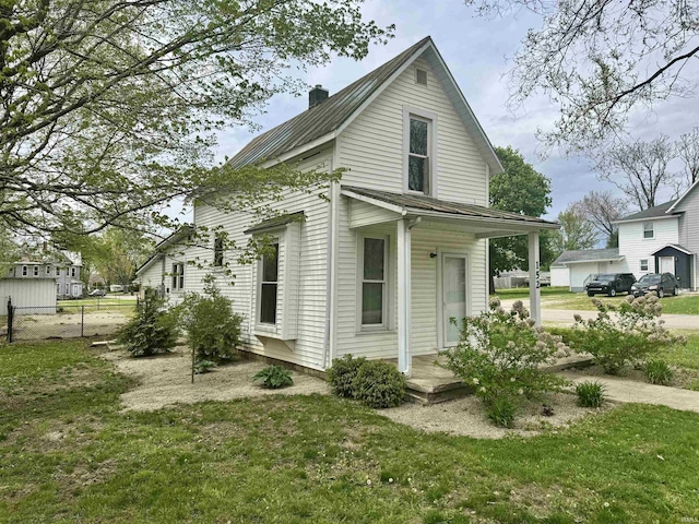 view of home's exterior with a yard, fence, and a chimney