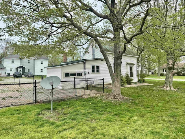 view of property exterior featuring a lawn, fence, and a chimney