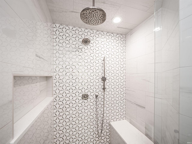 full bathroom featuring tile walls and a tile shower