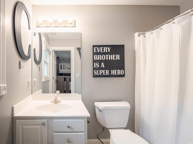 bathroom with vanity, toilet, and a shower with curtain